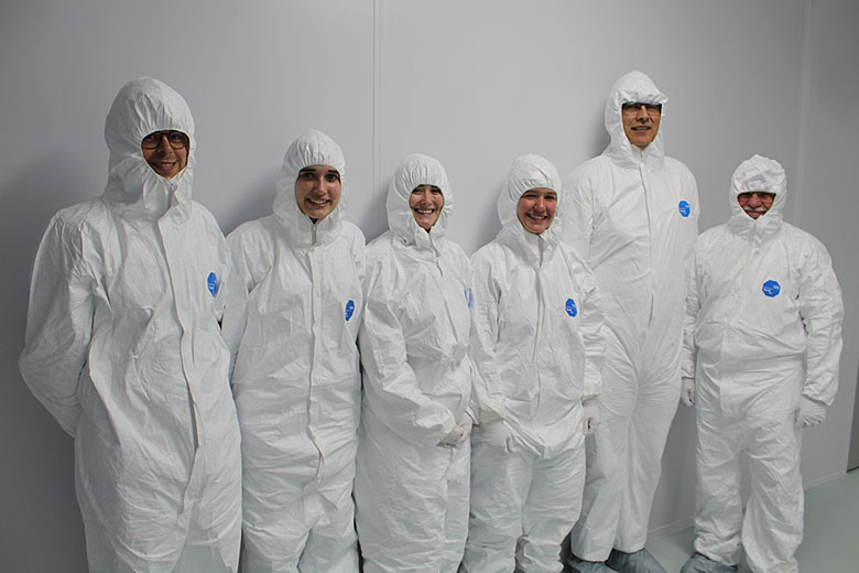 Workshop participants are happy to suit up and tour the clean room. From left: Nathan Whitman, Renee Kryk, Jennifer Robinson, Mikayla Hoyle, Paul Toren, and Steve Soper