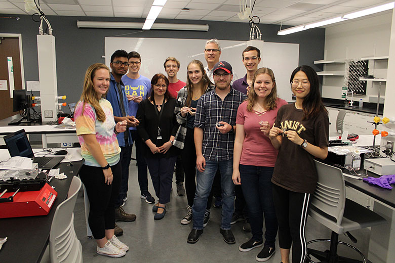 Workshop participants with their completed microfluidic devices. From left: Mikayla Hoyle, Abhik Manna, Nathan Whitman, Maggie Witek, Ian Freed, Renee Kryk, Paul Toren, Jay Sibbits, Logan Robart, Abigail Kreznor, Yeonzu Son
