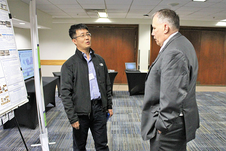 Dr. Daniel Park (left) and Dr. Michael Murphy (right) chat during the poster session