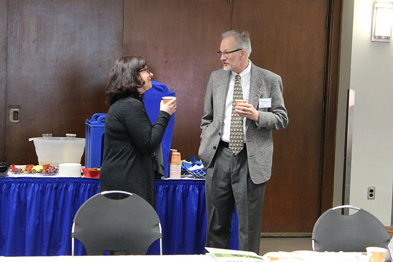 Dr. Maggie Witek enjoys a cup of coffee and conversation with Collin McKinney during breakfast