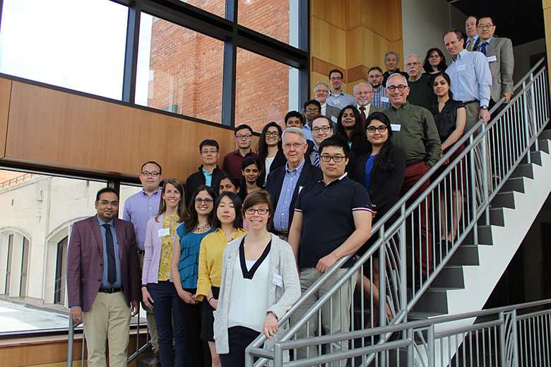 The attendees of the 2019 Team Meeting and EAB Meeting standing on a staircase.