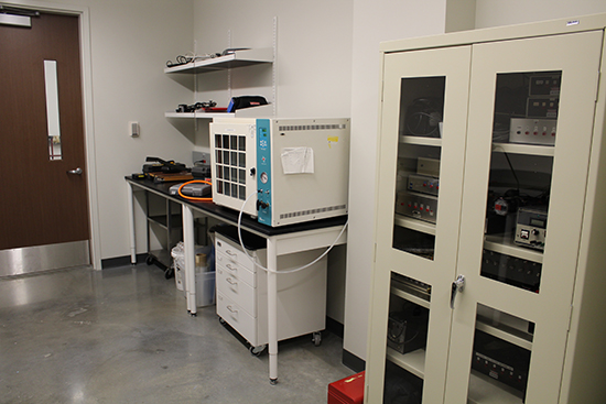 Chip prep room, displaying a wall with shelving and a table, next to a cabinet