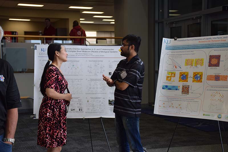Wenting Hu speaking to a member of the Paul Hanson group at the Saturday poster session