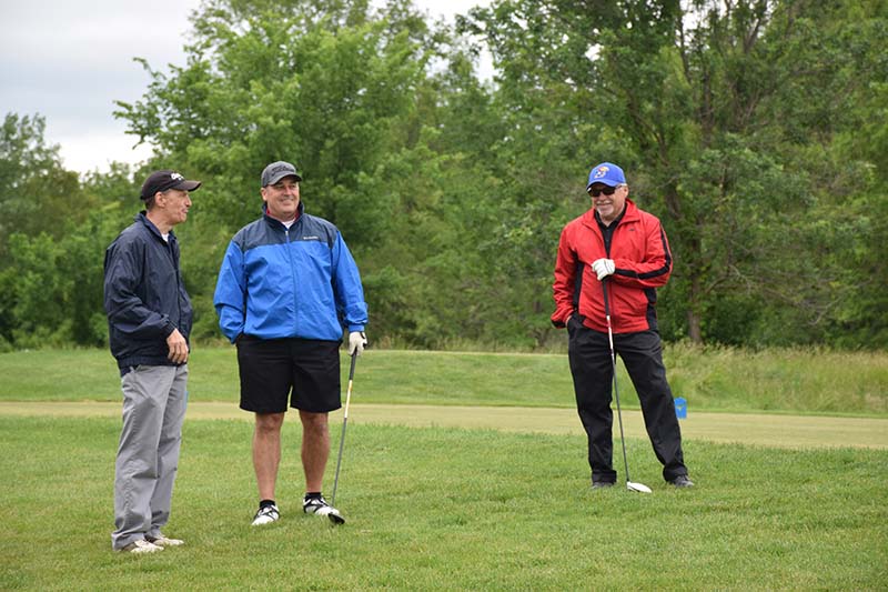 Steve Soper, right, waits his turn to golf with Bob Dunn and Pete Knutson at the Saturday afternoon golf outing in memory of Craig Lunte